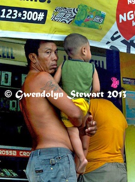 Family Shopping at a Roadside Cellphone Stall on Bali, Indonesia,
Photographed by Gwendolyn Stewart, c. 2014; All Rights Reserved